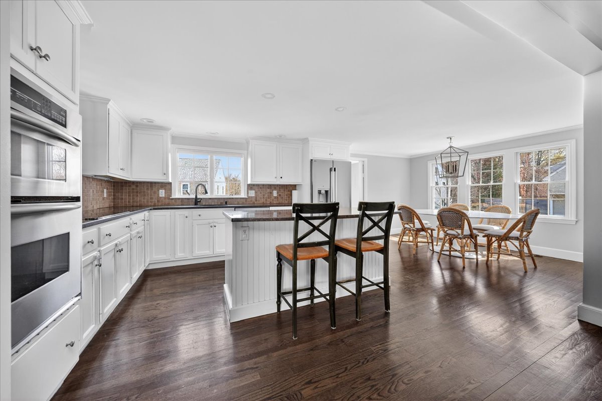 6 Studley Road Hingham, MA 02043 - Photo 8 of 27 a large kitchen with white cabinets and stainless steel appliances