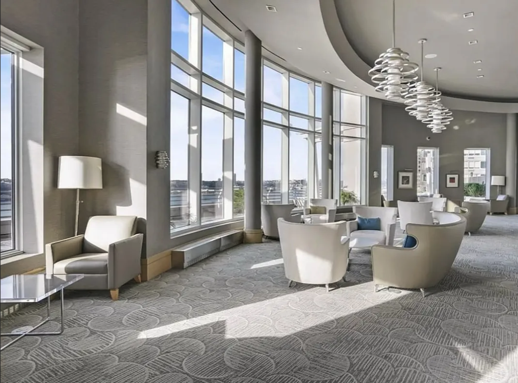 120 Riverside Boulevard, Unit 10W Manhattan, NY 10069 - Photo 10 of 13 a living room with couches a table and chairs