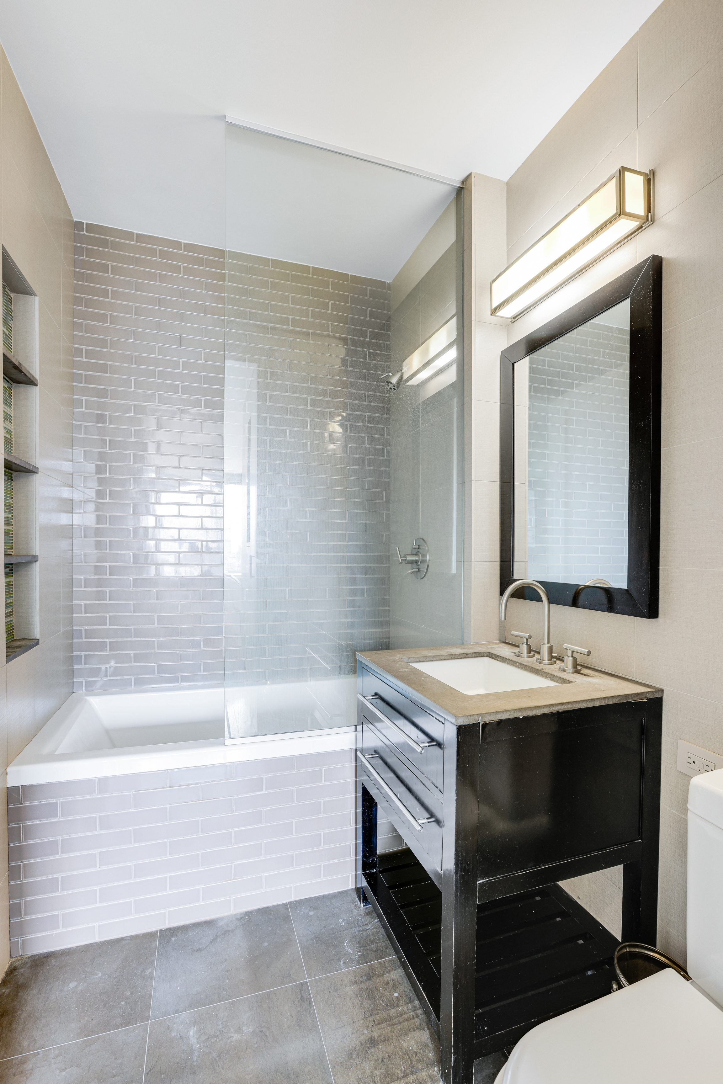 111 West 67th Street, Unit 34F Manhattan, NY 10023 - Photo 7 of 11 a bathroom with a sink and a bathtub