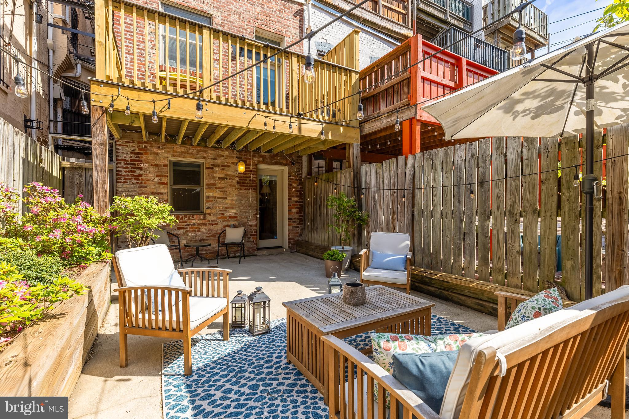 a view of a patio with a table and chairs