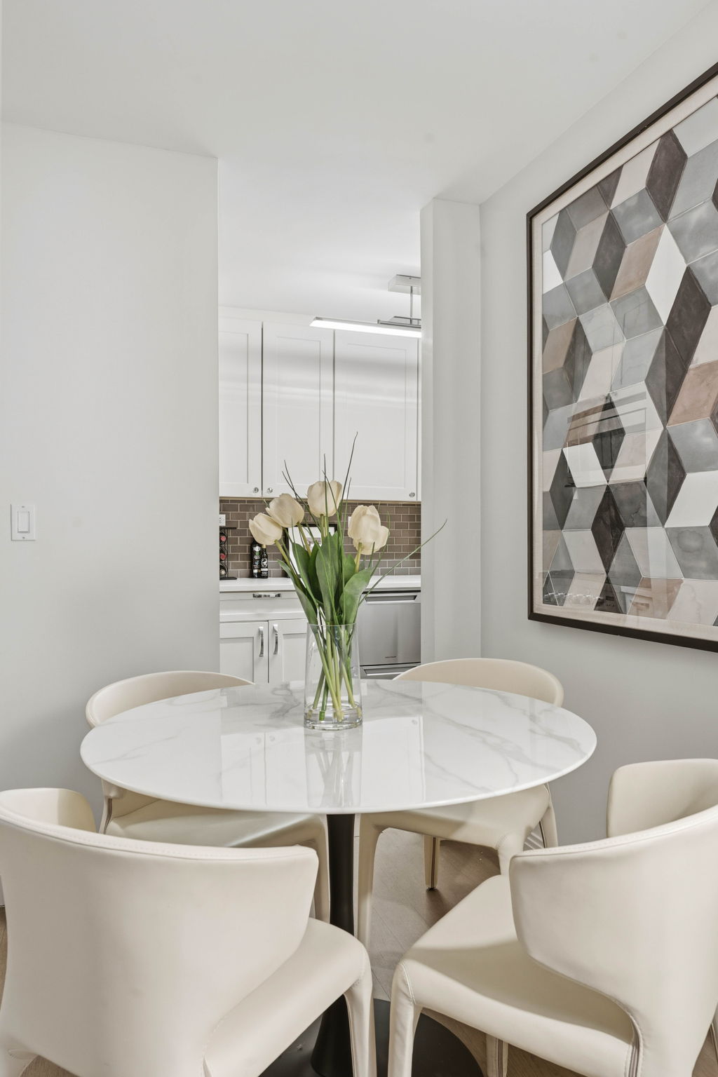245 East 87th Street, Unit 17C Manhattan, NY 10128 - Photo 4 of 11 a dining room with furniture and wooden floor