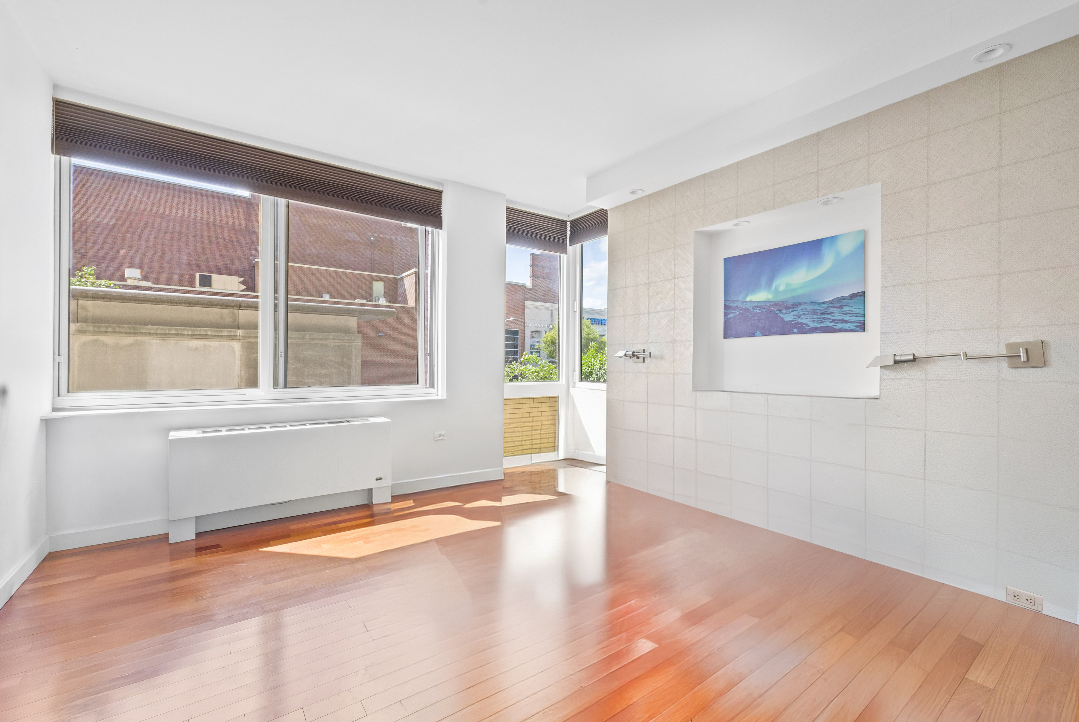 107-24 71st Road, Unit 2E Queens, NY 11375 - Photo 6 of 18 a view of an empty room with a window and wooden floor