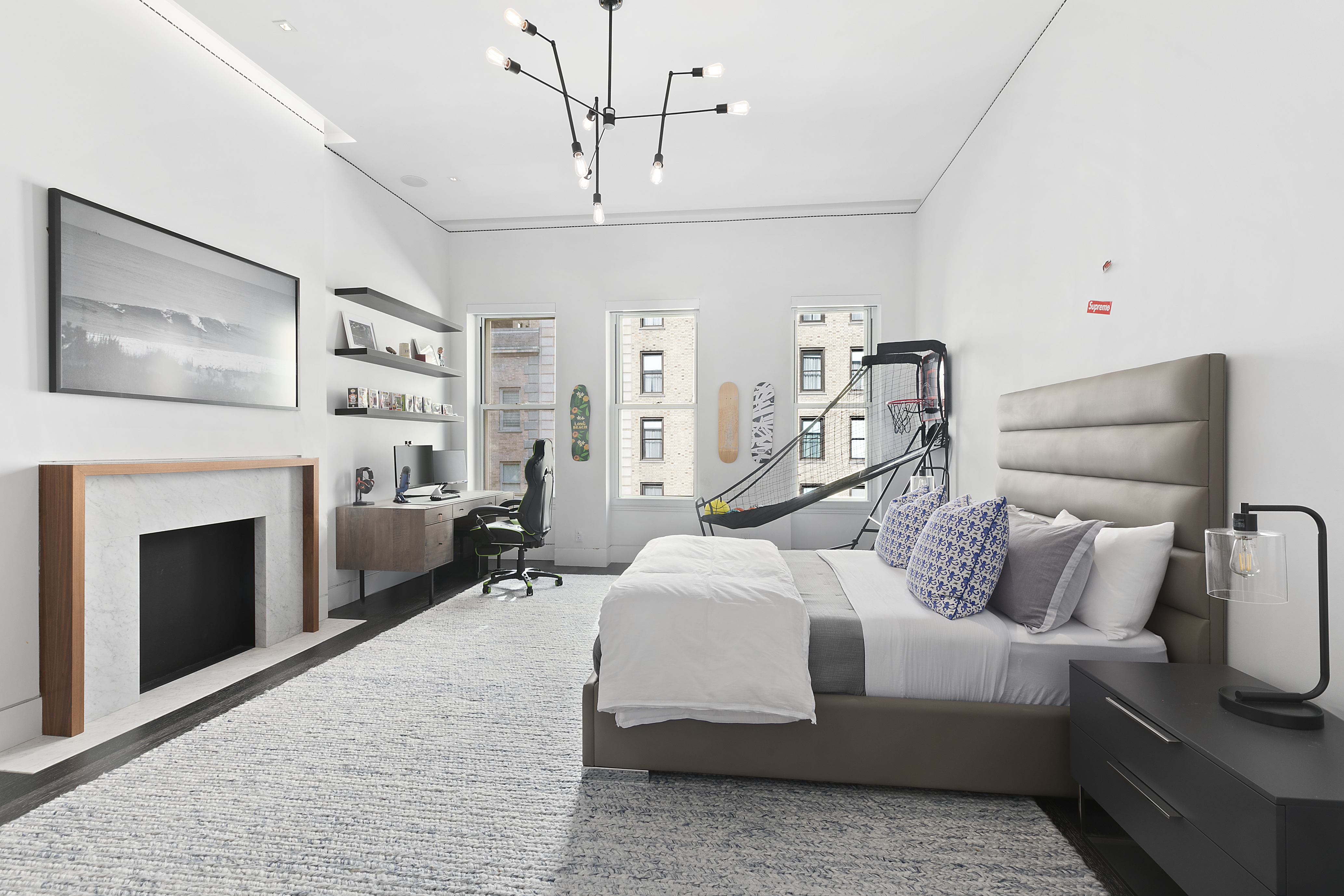 36 East 64th Street Manhattan, NY 10065 - Photo 21 of 27 a bedroom with a bed and a fireplace