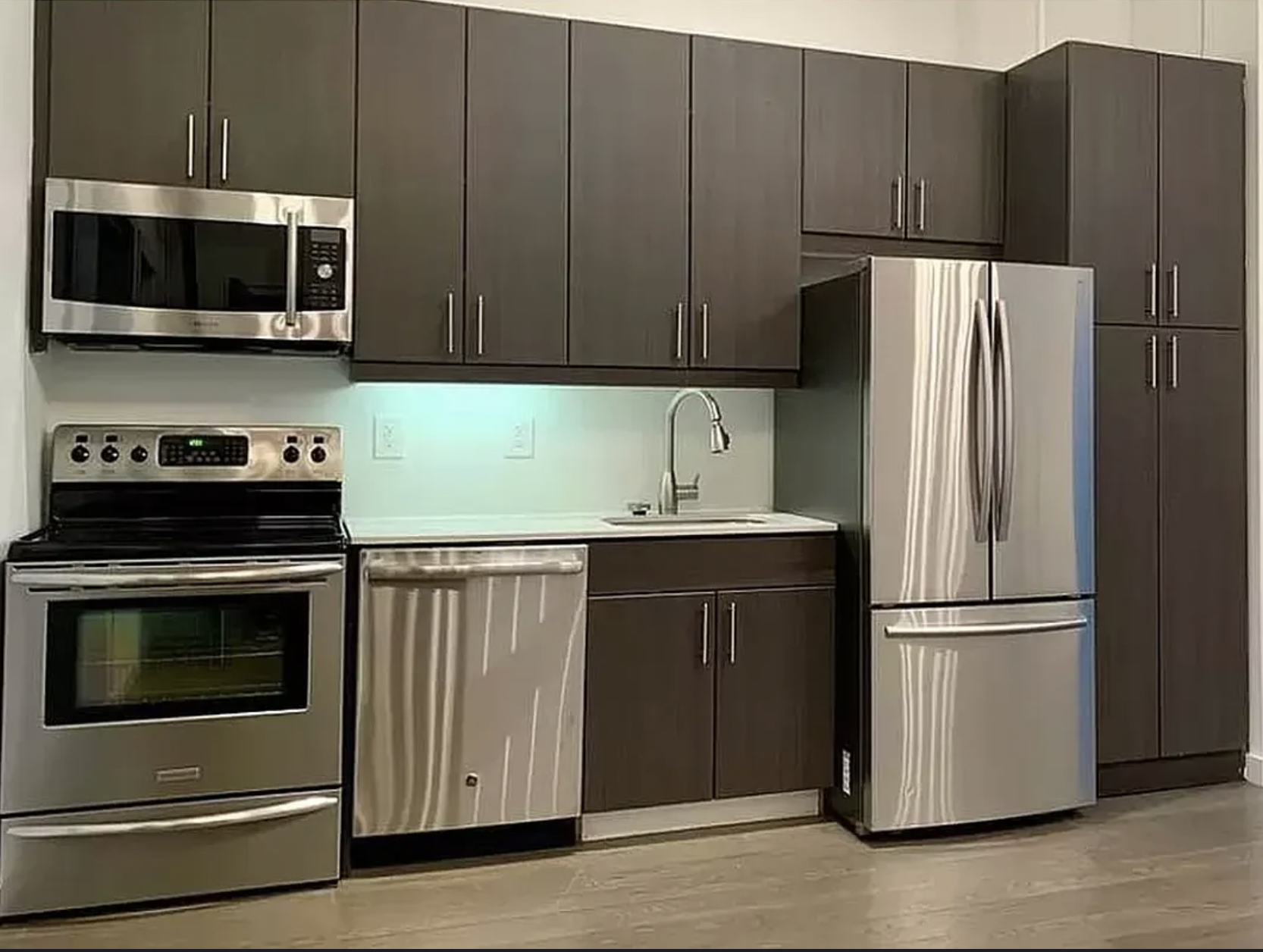 44 Berry Street, Unit 3A Brooklyn, NY 11249 - Photo 2 of 8 a kitchen with stainless steel appliances granite countertop a refrigerator stove and microwave