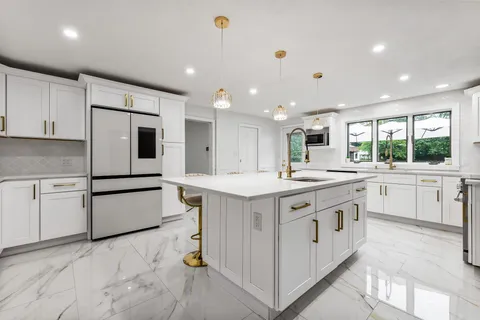 a kitchen with stainless steel appliances granite countertop a sink and cabinets