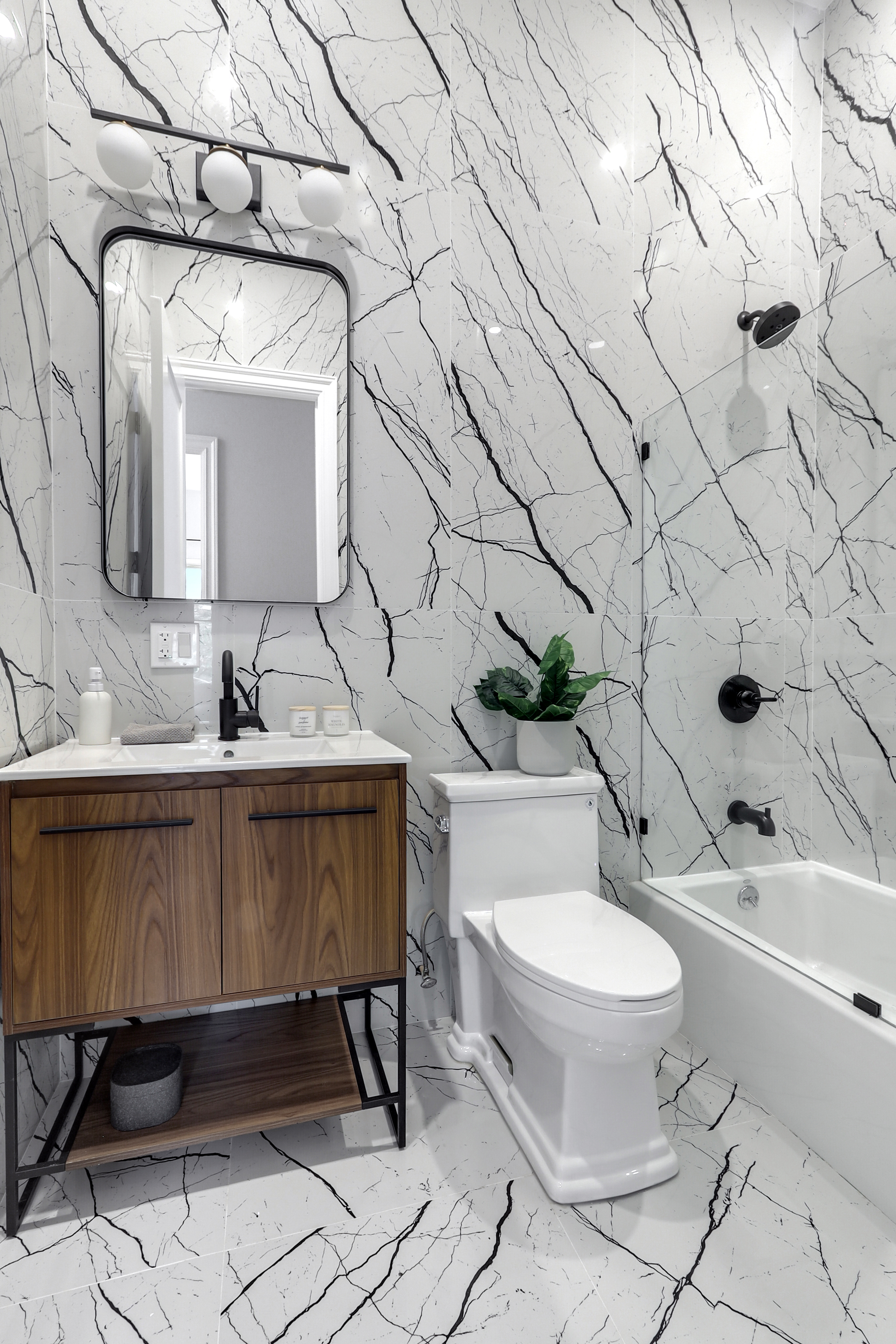 220 Lewis Avenue Brooklyn, NY 11221 - Photo 17 of 22 a bathroom with a toilet sink and mirror