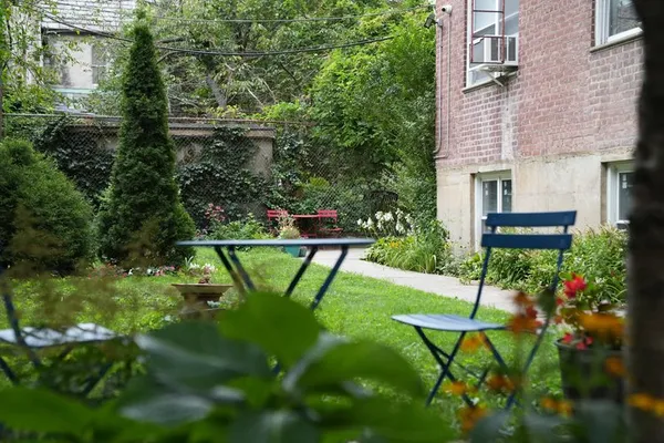 a view of an chairs and bench in the yard