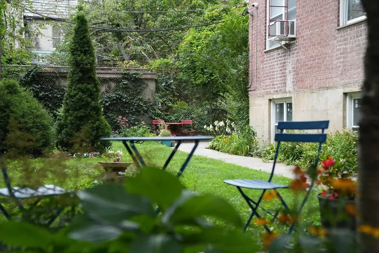 a view of an chairs and bench in the yard