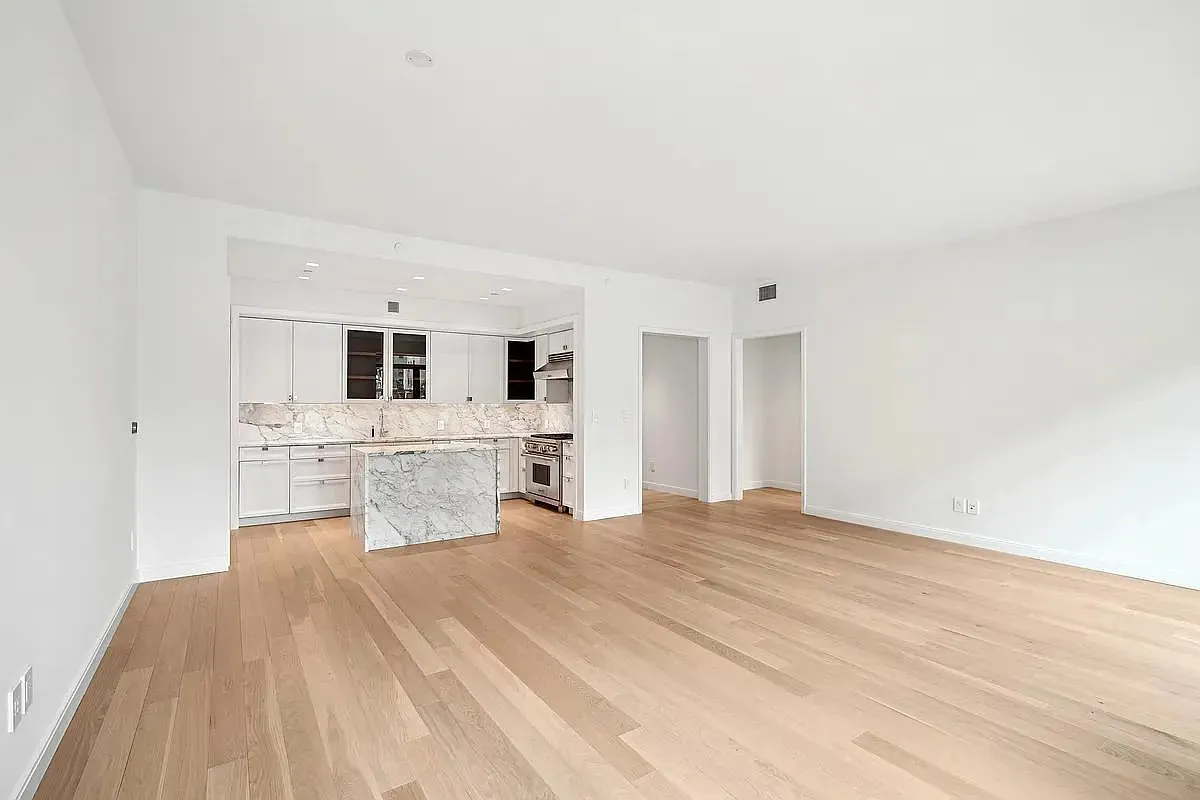 a large white bed in a white room