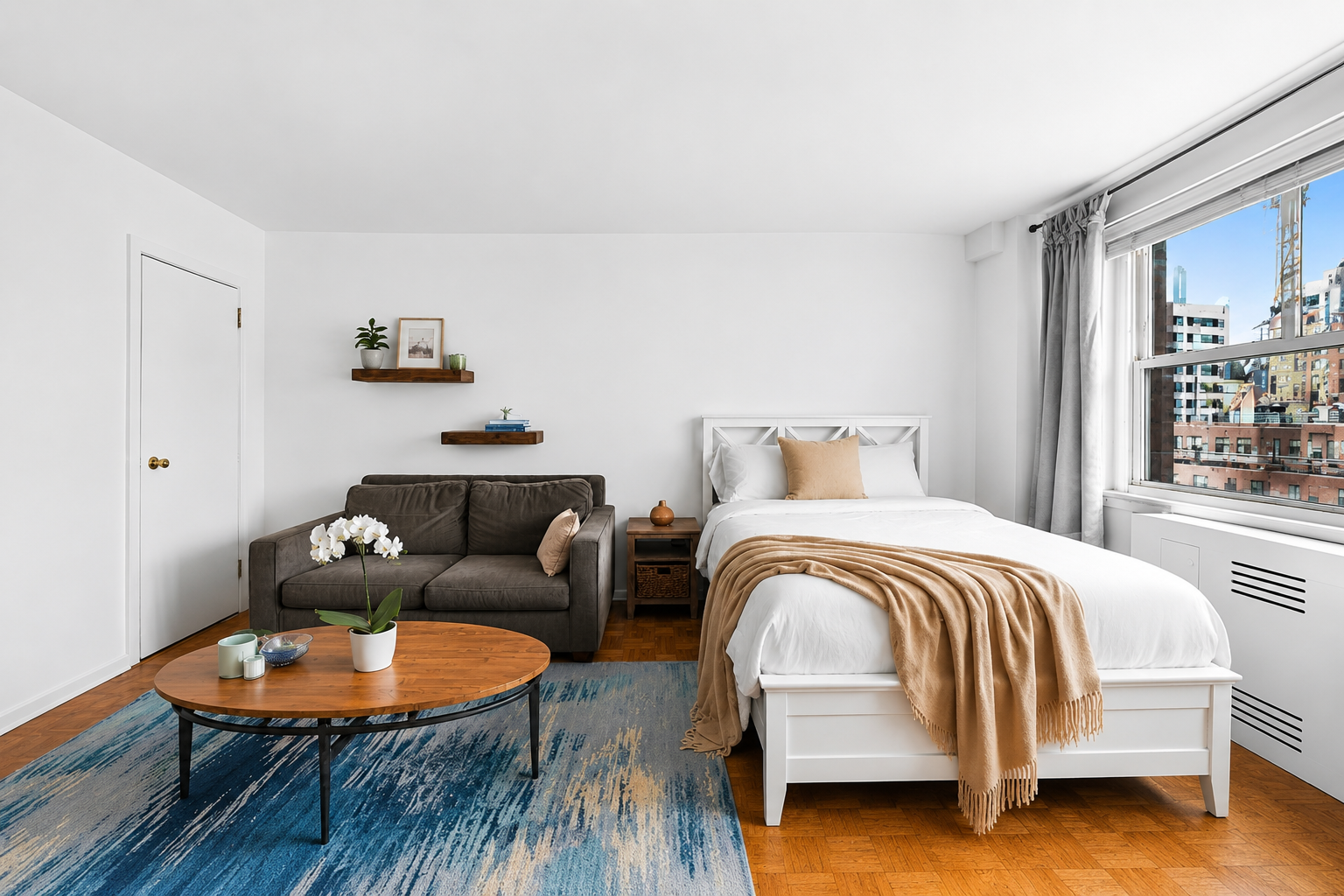233 East 69th Street, Unit 16F Manhattan, NY 10021 - Photo 2 of 11 a bedroom with a bed and wooden floor