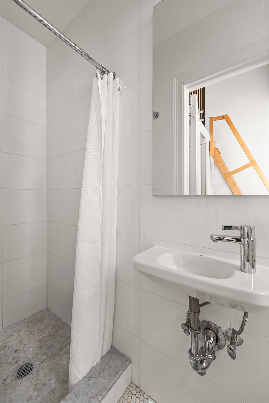 895 West End Avenue, Unit 1B Manhattan, NY 10025 - Photo 18 of 23 a bathroom with a sink a mirror and a shower