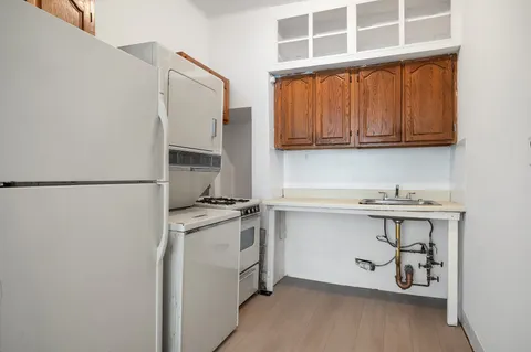 a kitchen with stainless steel appliances granite countertop a stove a sink and a refrigerator