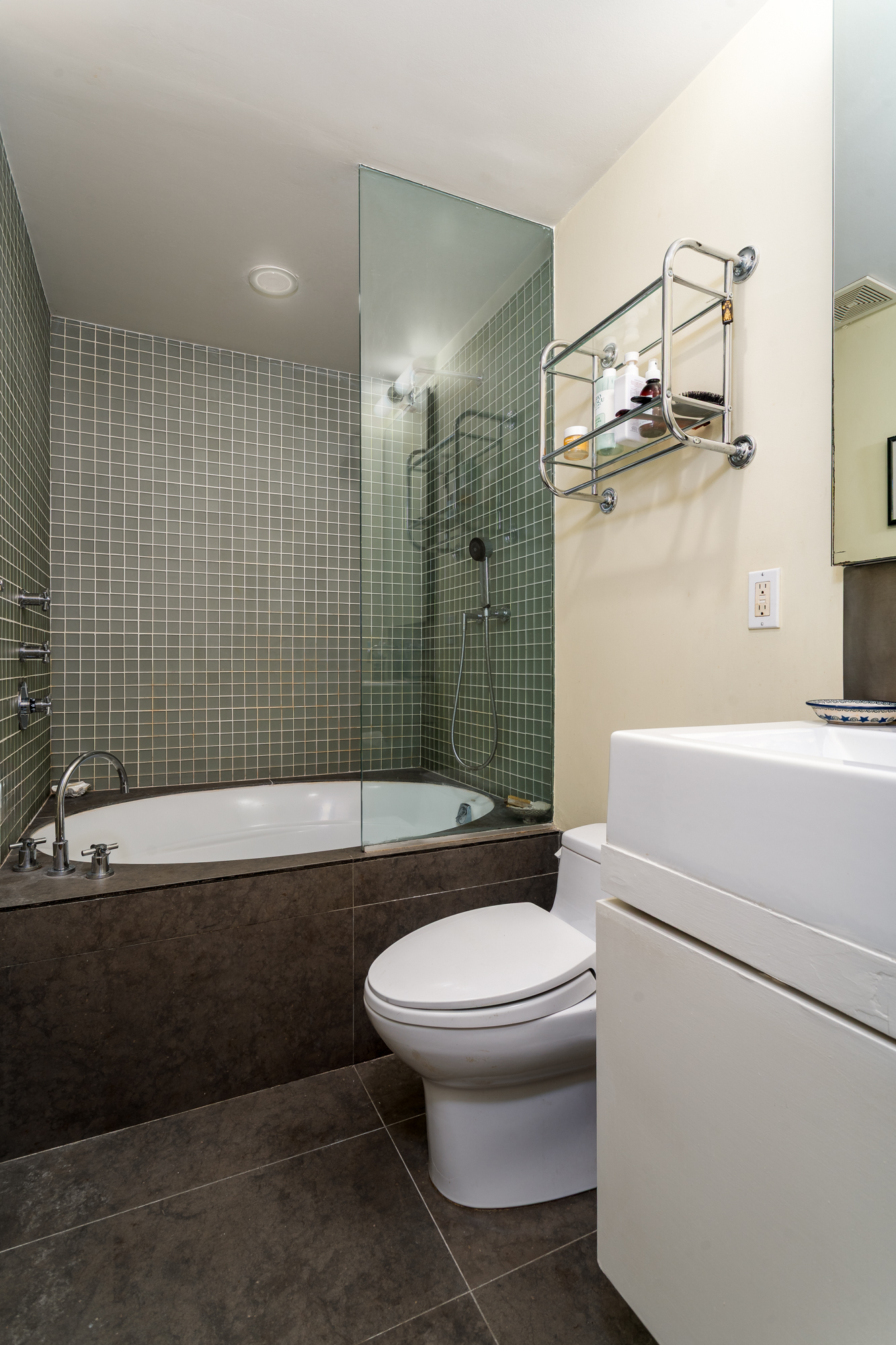 432 East 85th Street, Unit 1R Manhattan, NY 10028 - Photo 8 of 14 a bathroom with a sink a toilet and shower