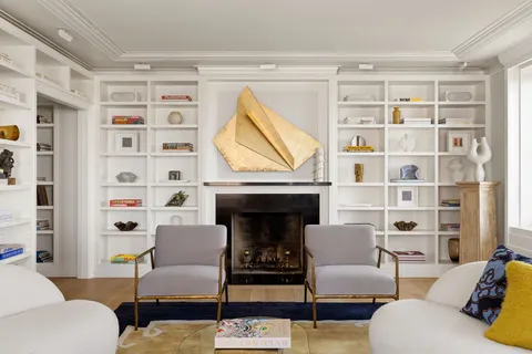 a living room with furniture a fireplace and a window