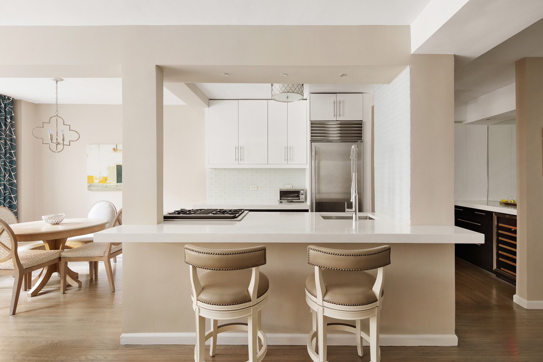 11 5th Avenue, Unit 3E Manhattan, NY 10003 - Photo 2 of 6 a kitchen with granite countertop a table chairs stove and cabinets