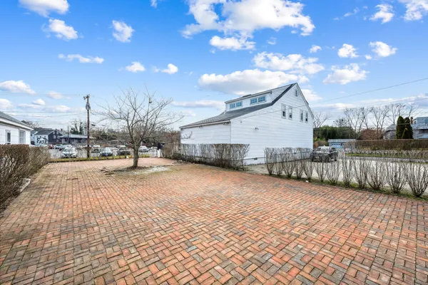 a view of a yard with wooden fence