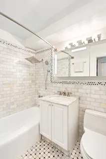 a bathroom with a sink a toilet and a bathtub
