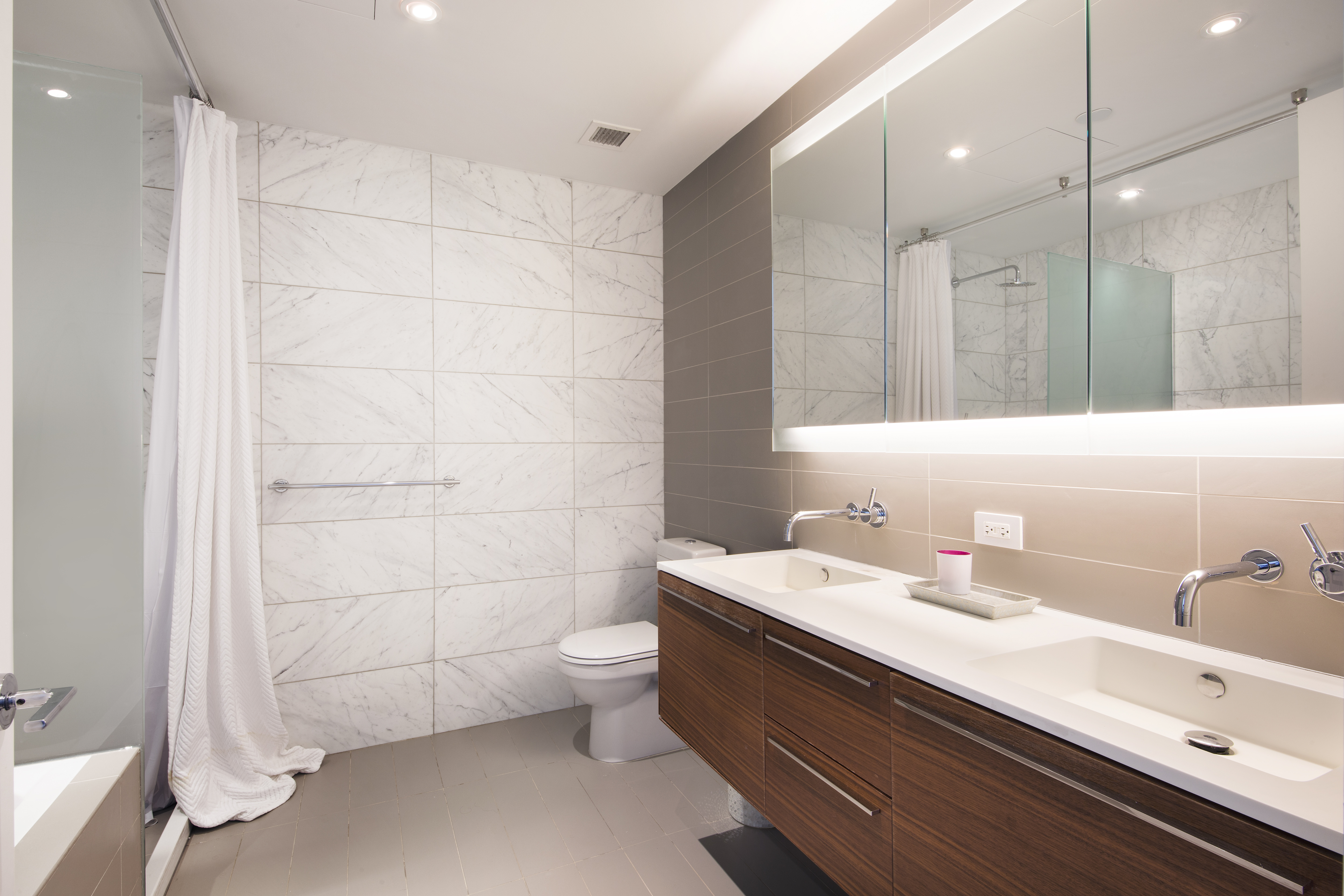 123 3rd Avenue, Unit 11A Manhattan, NY 10003 - Photo 6 of 11 a bathroom with a sink a toilet and shower
