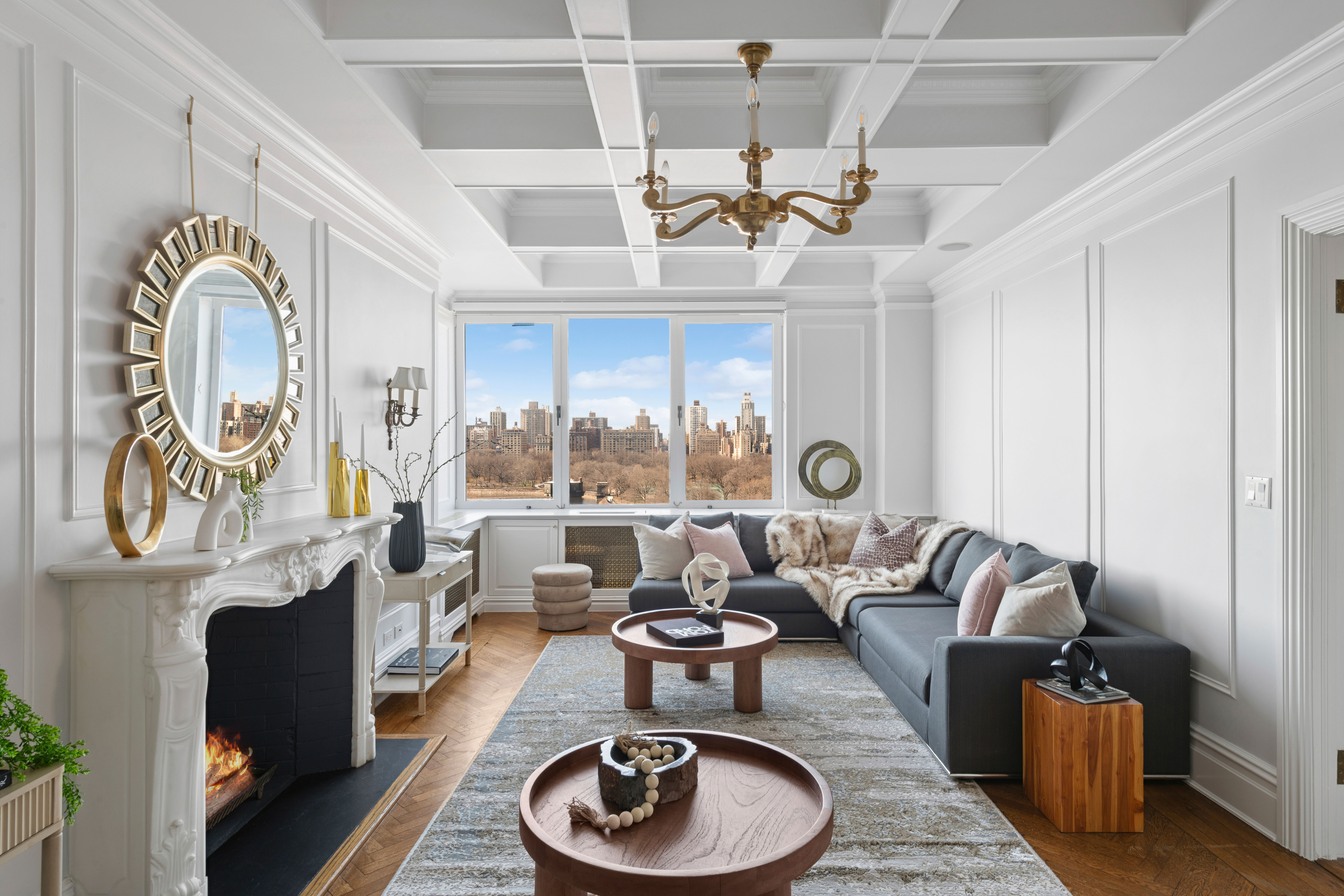 1140 5th Avenue, Unit 14B Manhattan, NY 10128 - Photo 2 of 18 a living room with furniture a rug and a chandelier