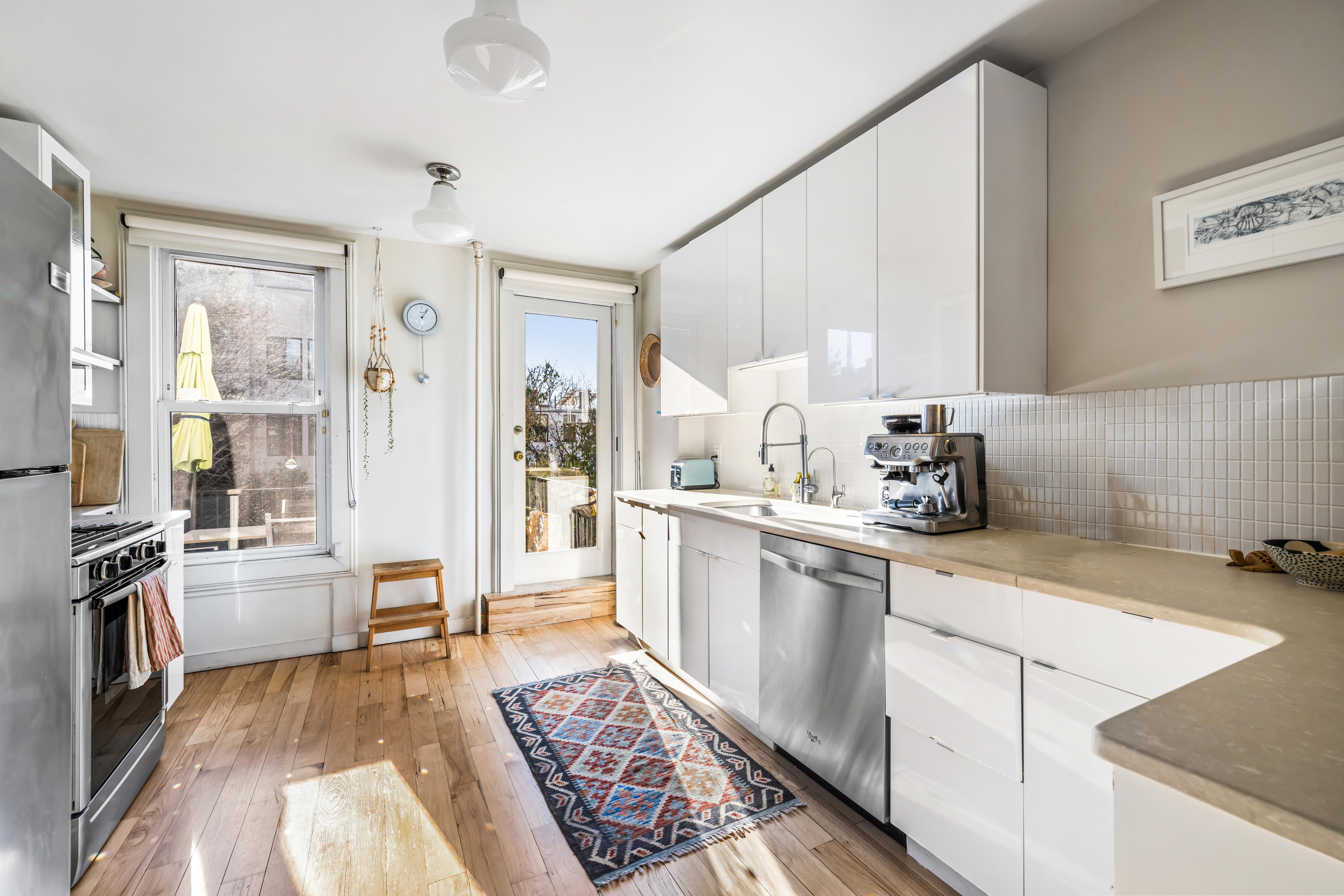 226 11th Street, Unit 2 Brooklyn, NY 11215 - Photo 4 of 19 a open kitchen with stainless steel appliances granite countertop a sink stove and refrigerator