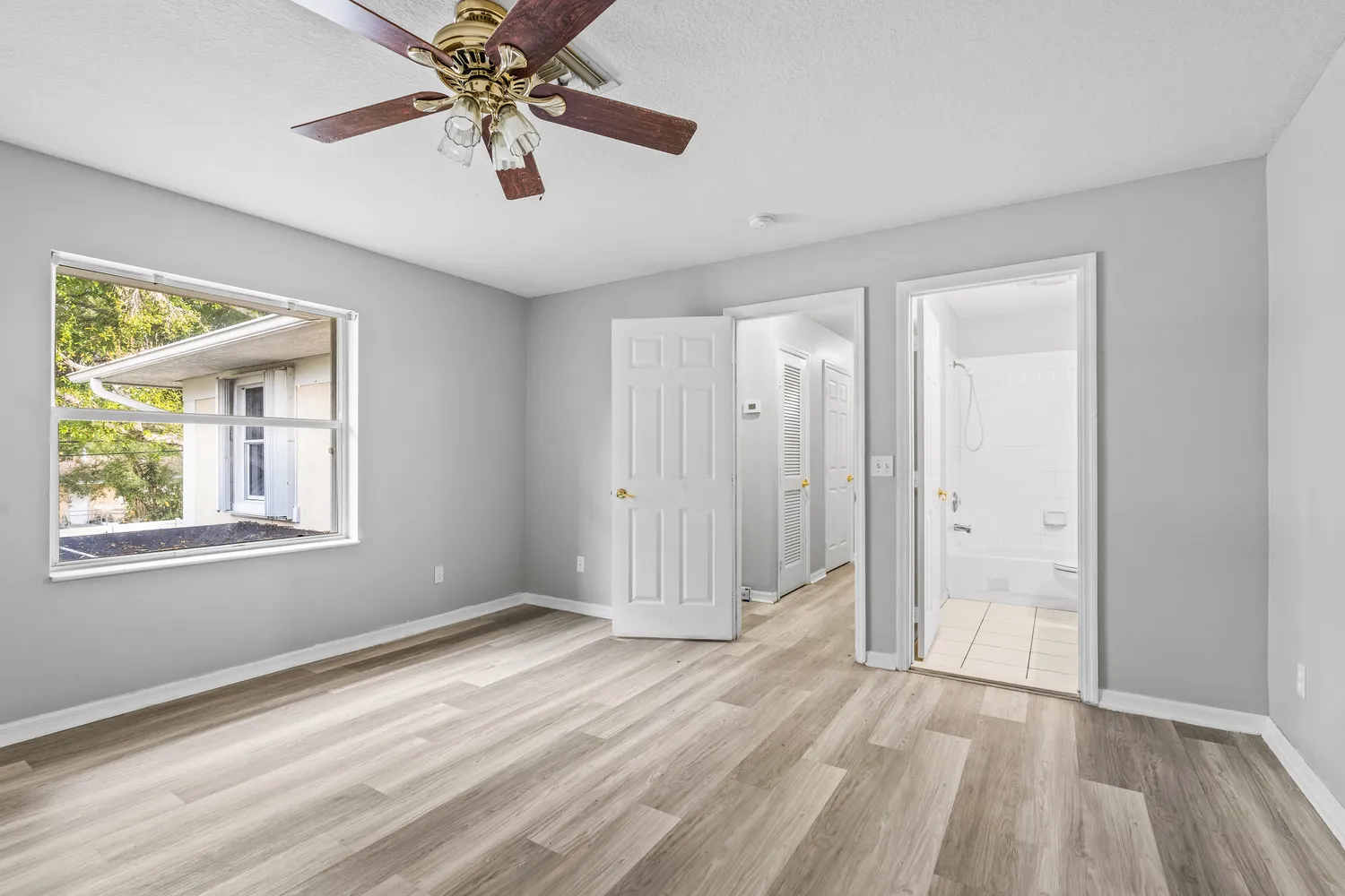 wooden floor in an empty room with a window