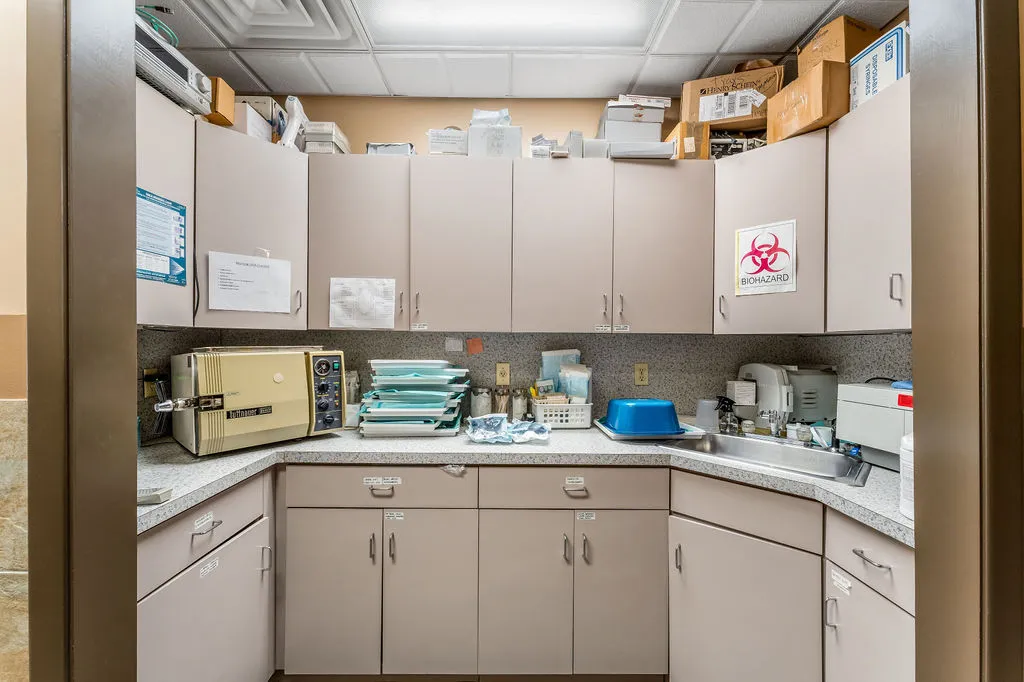 a view of a workspace with furniture and a bookshelf
