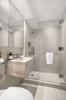 a bathroom with a tub a sink and mirror