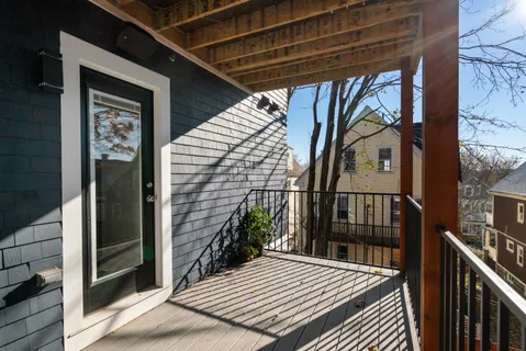 a view of balcony with wooden floor and fence