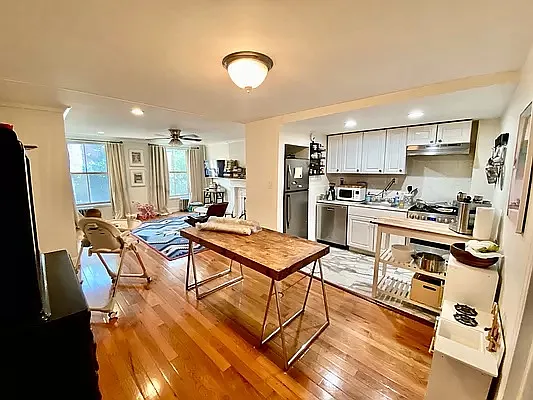 195 Atlantic Avenue, Unit 1 Brooklyn, NY 11201 - Photo 3 of 10 a living room with stainless steel appliances furniture a rug and a kitchen view