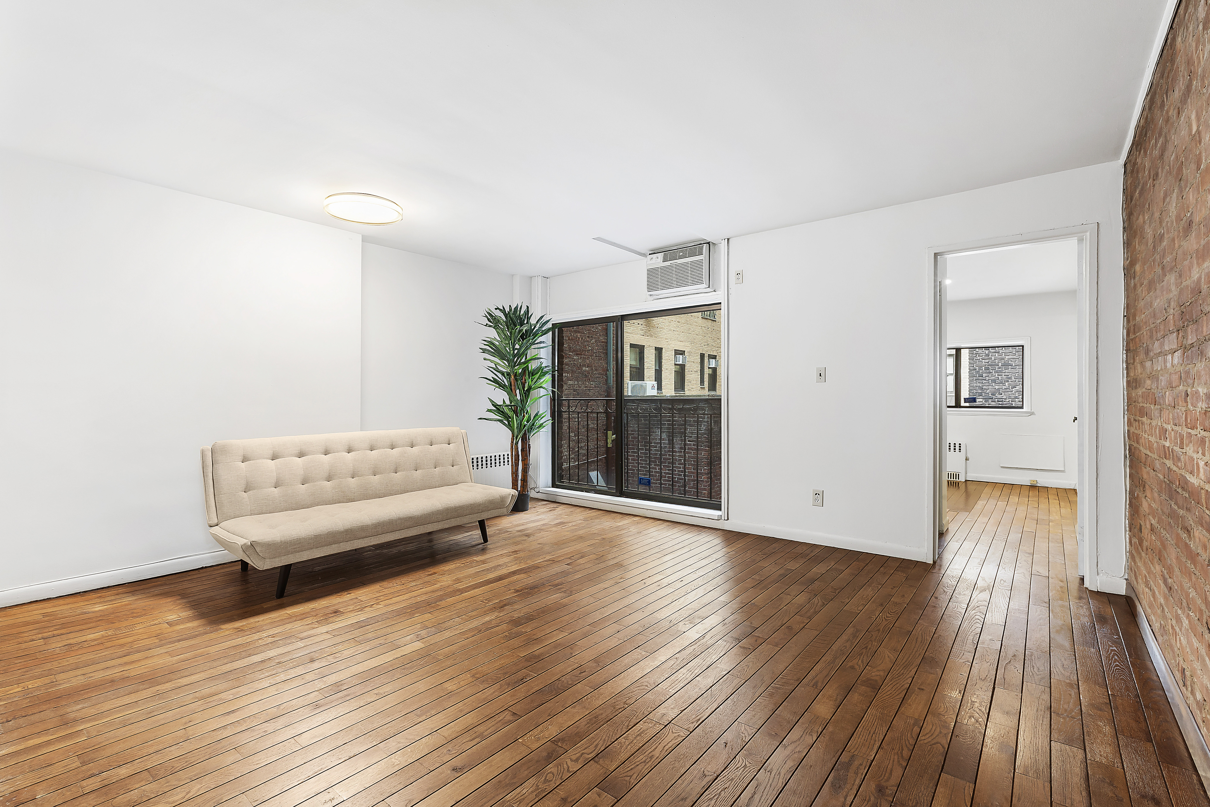 59 East 74th Street, Unit 6A Manhattan, NY 10021 - Photo 1 of 5 a living room with furniture and a wooden floor