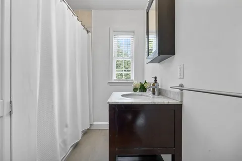 a dining room with table chairs and a window