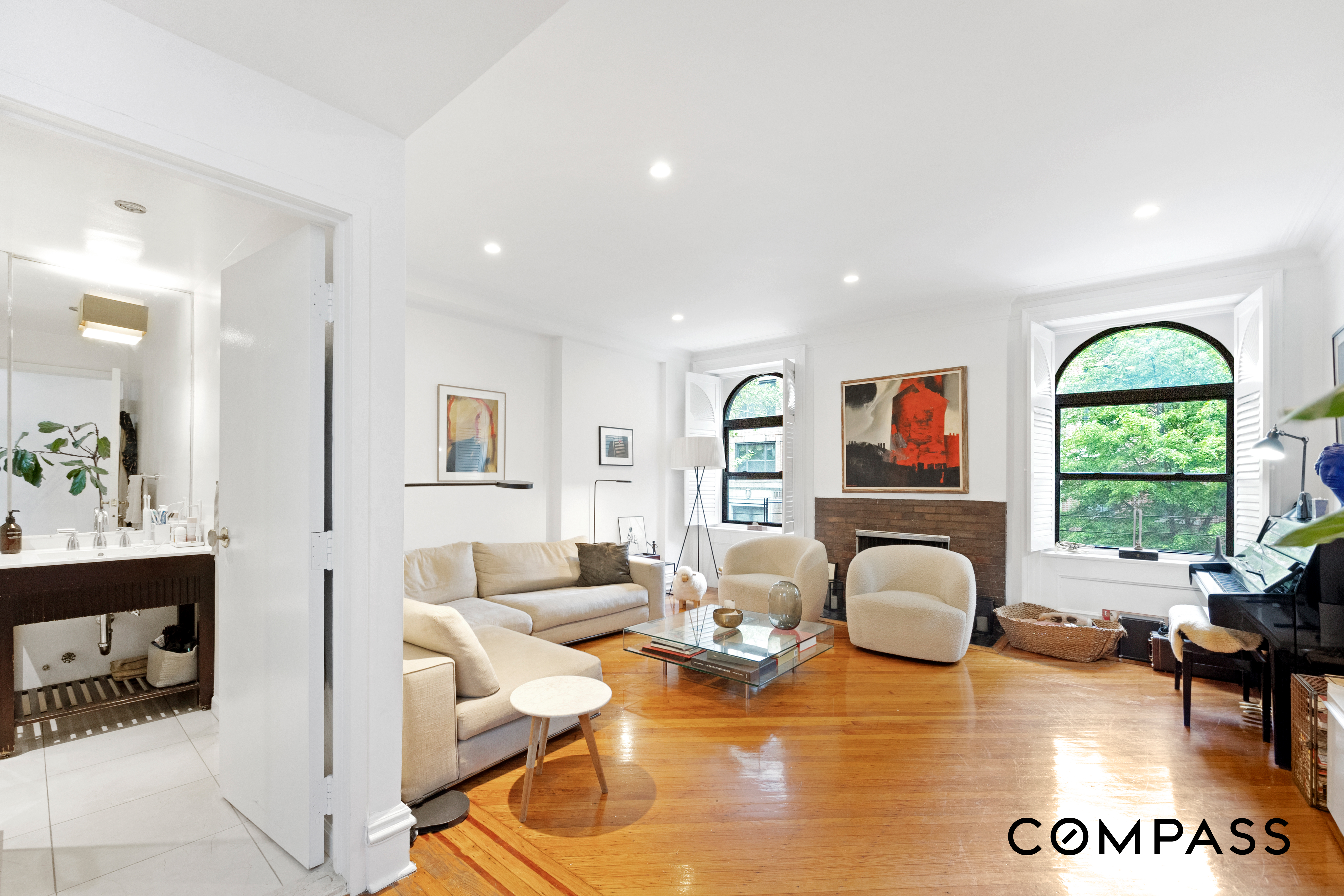 152 East 74th Street, Unit 2 Manhattan, NY 10021 - Photo 3 of 16 a living room with fireplace furniture and a large window