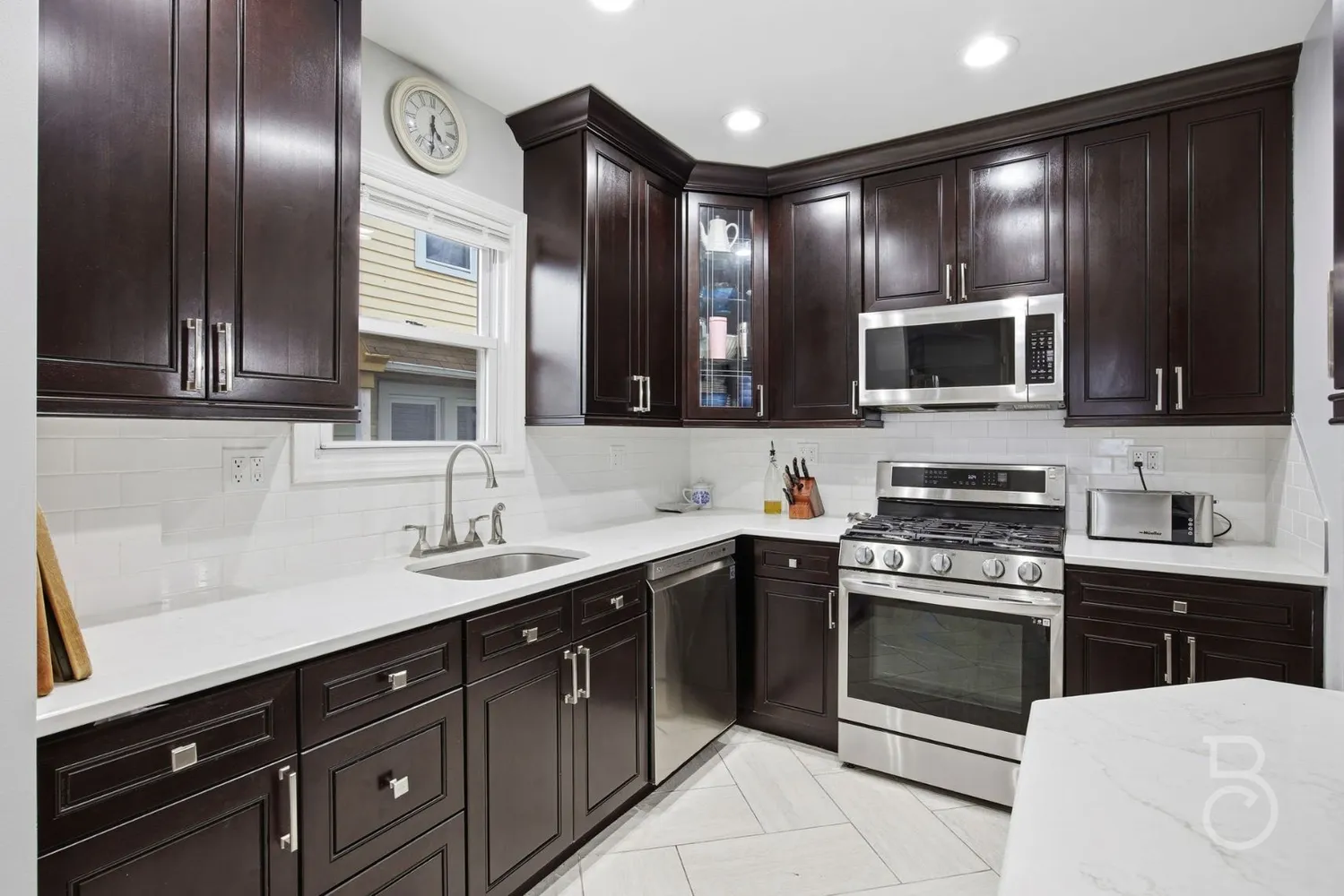 a kitchen with stainless steel appliances granite countertop a sink and stove top oven