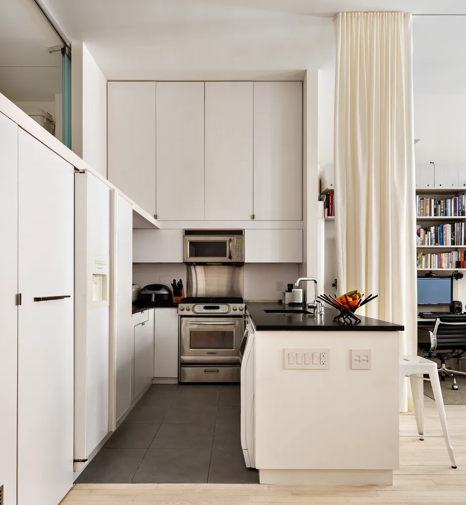a kitchen with stainless steel appliances a refrigerator sink and cabinets