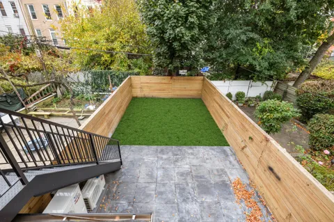 a view of a backyard with sitting area