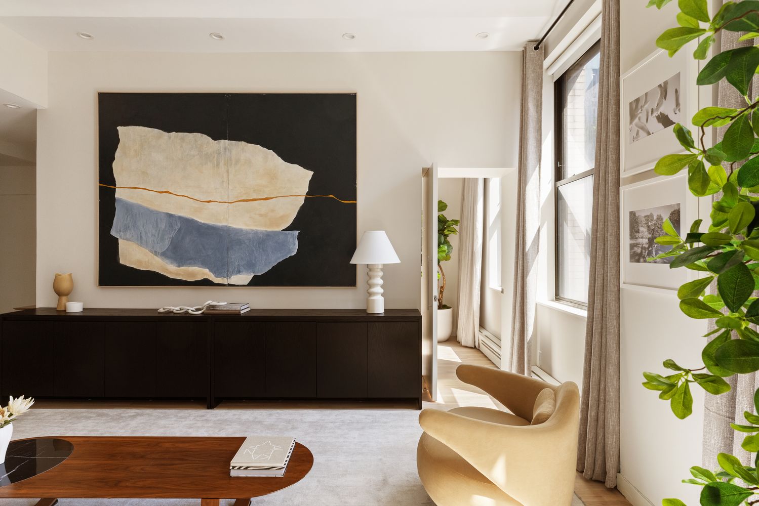 a living room with a couch and potted plant