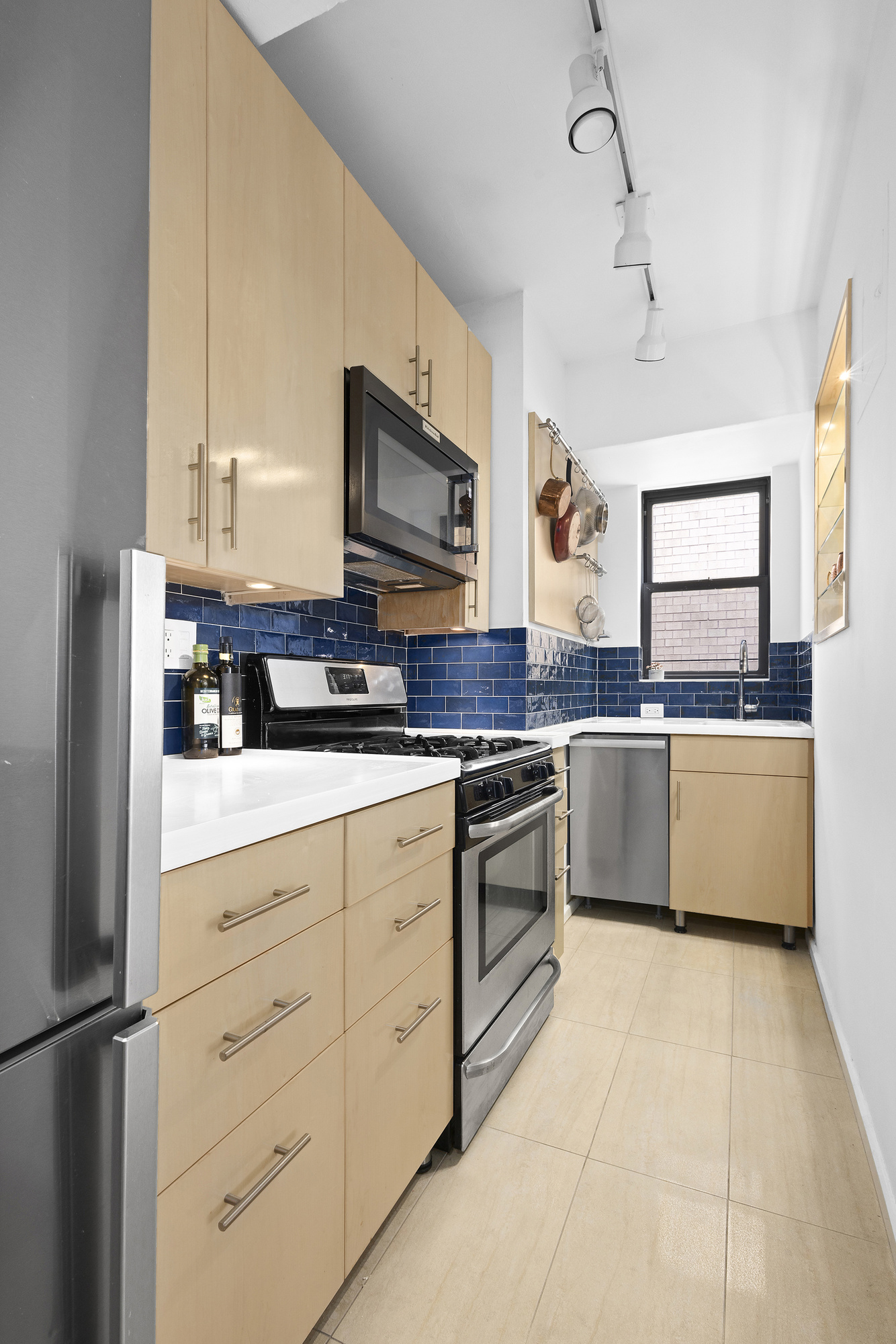 240 East 46th Street, Unit PHC Manhattan, NY 10017 - Photo 3 of 6 a kitchen with granite countertop a sink stainless steel appliances and cabinets