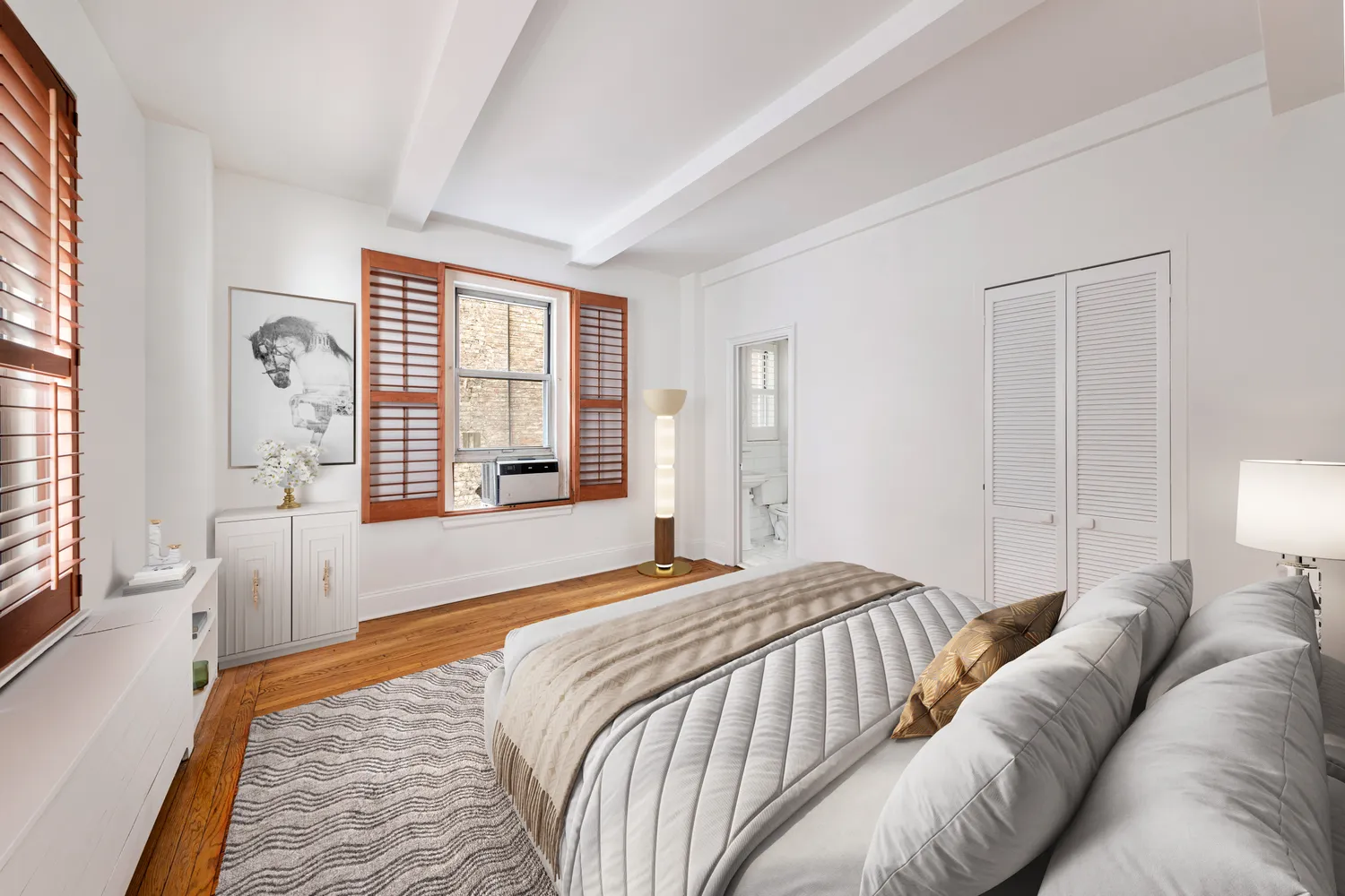 a bedroom with a bed and a couch with large window