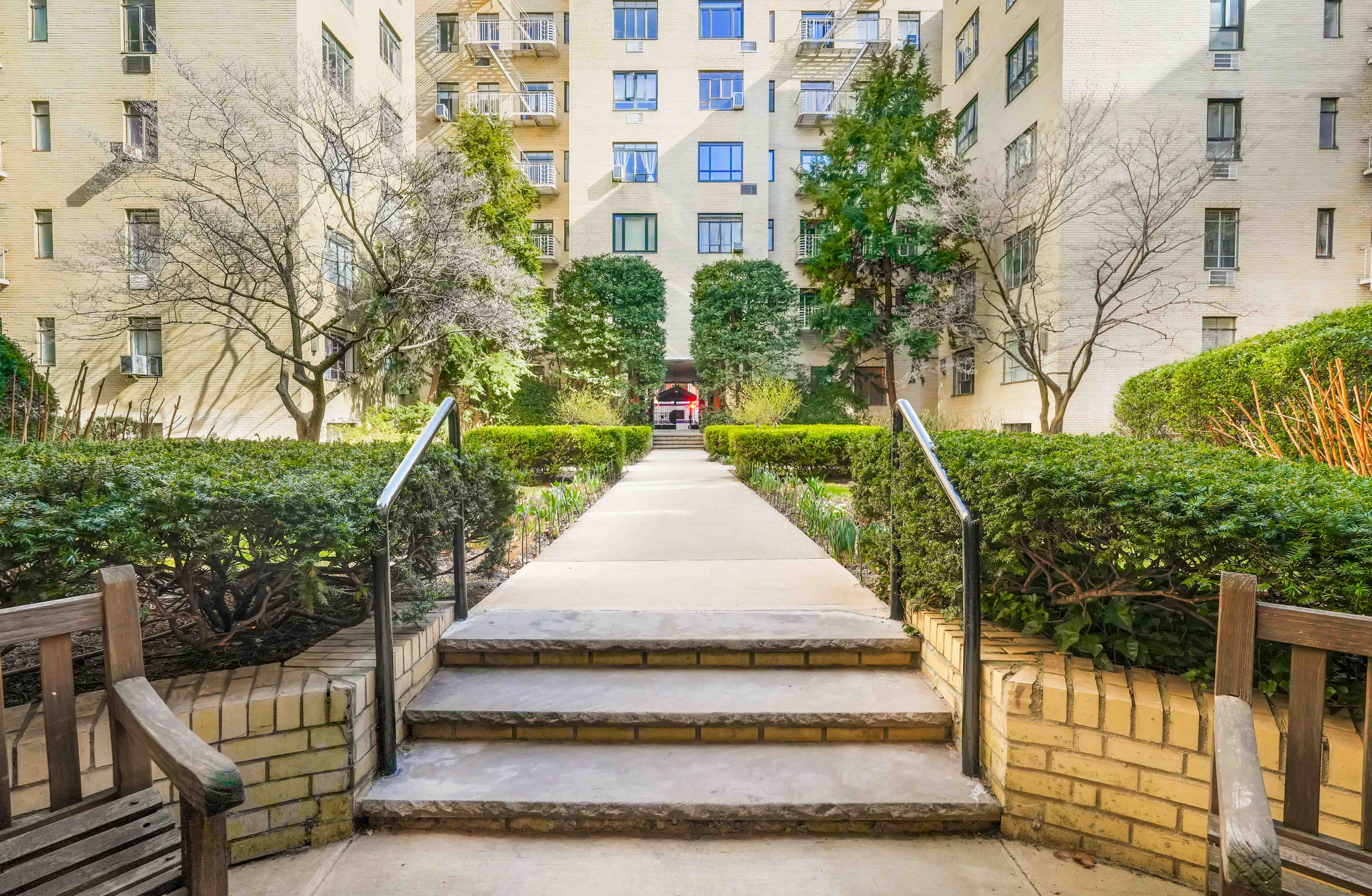 255 West 23rd Street, Unit 5GW Manhattan, NY 10011 - Photo 26 of 35 a view of a white house with a yard and potted plants