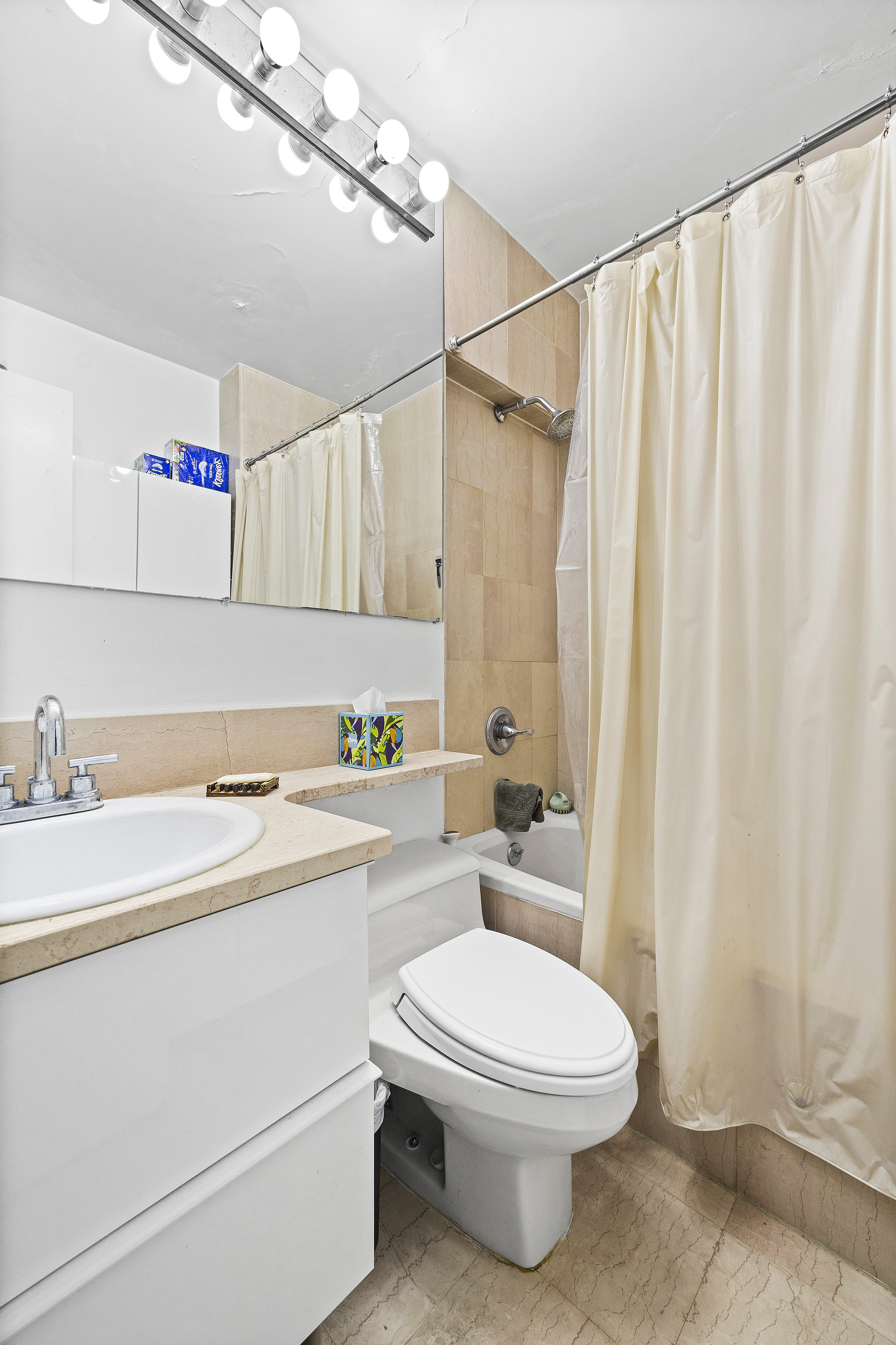 455 East 86th Street, Unit 5E Manhattan, NY 10028 - Photo 4 of 5 a bathroom with a toilet a sink and a shower