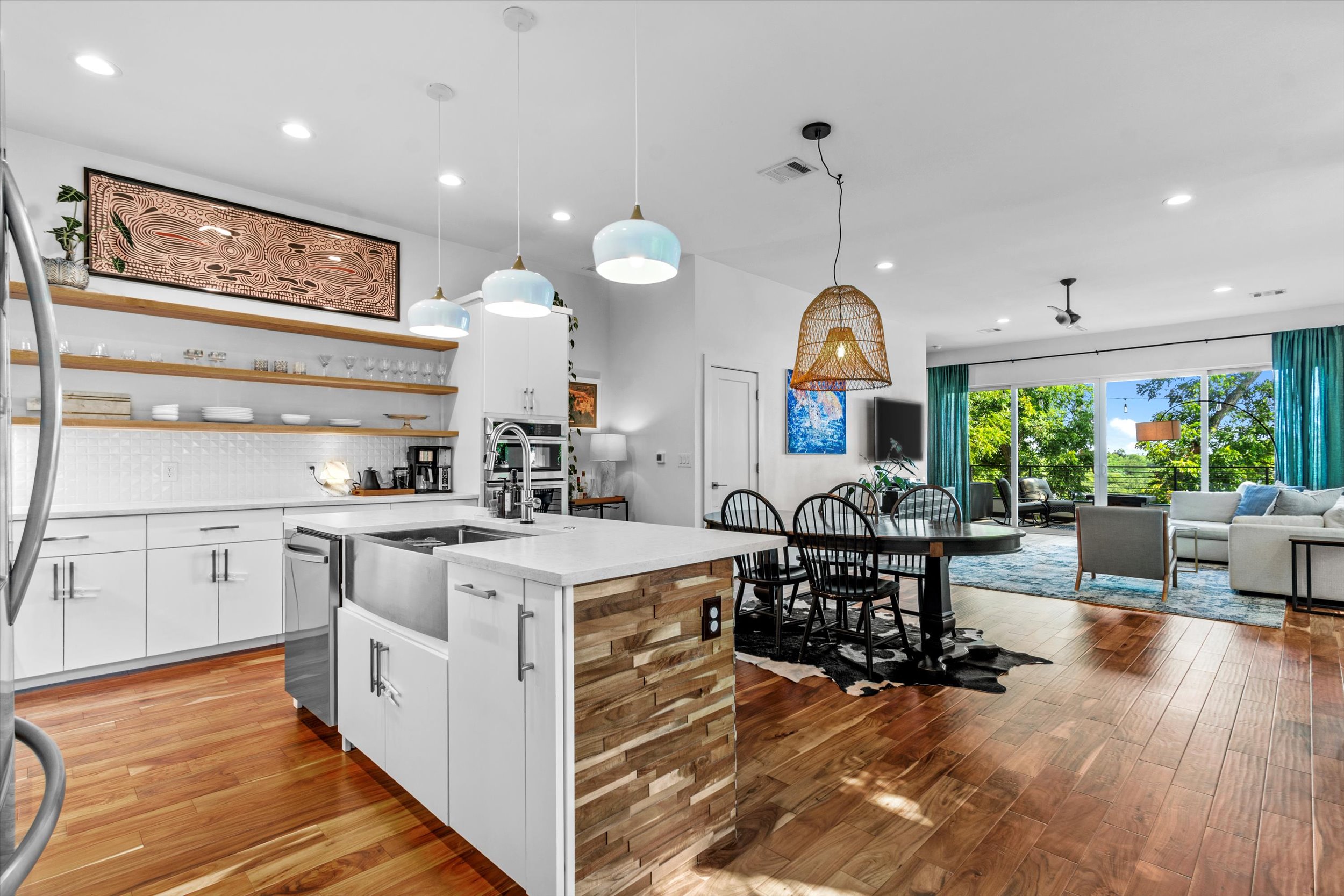 2712 Oak Springs Drive, Unit A Austin, TX 78702 - Photo 22 of 38 a large kitchen with stainless steel appliances granite countertop a stove and a view of dining hall with wooden floor