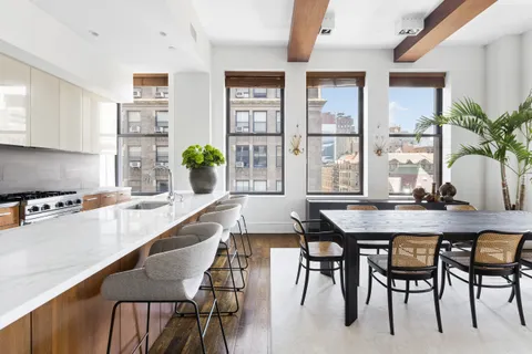a kitchen with a table chairs and counter space