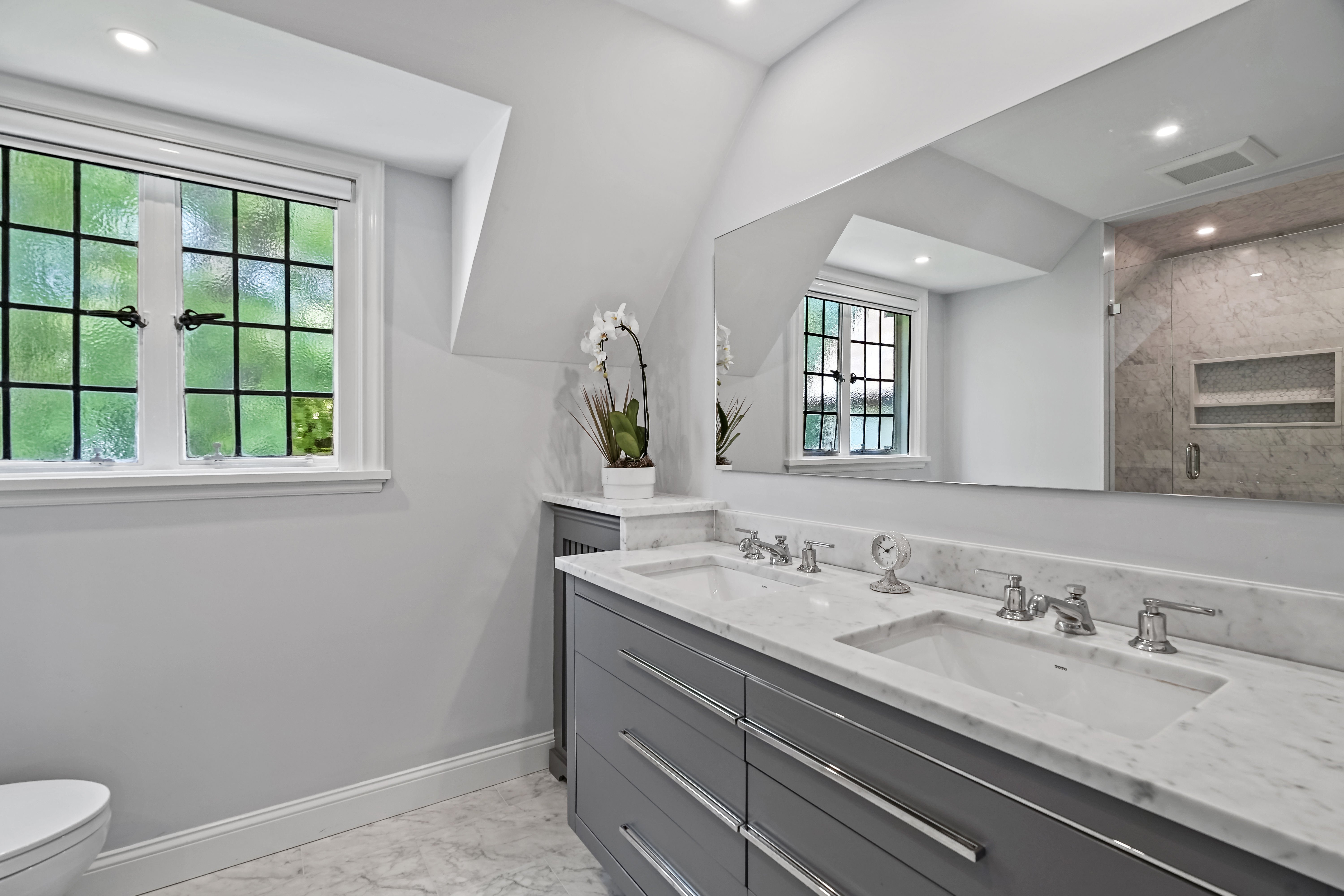 19 Avon Road Larchmont, NY 10538 - Photo 13 of 35 a bathroom with a granite countertop sink a toilet and a window
