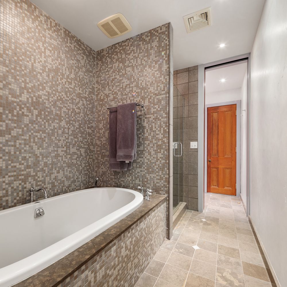 a bathroom with a bathtub and shower