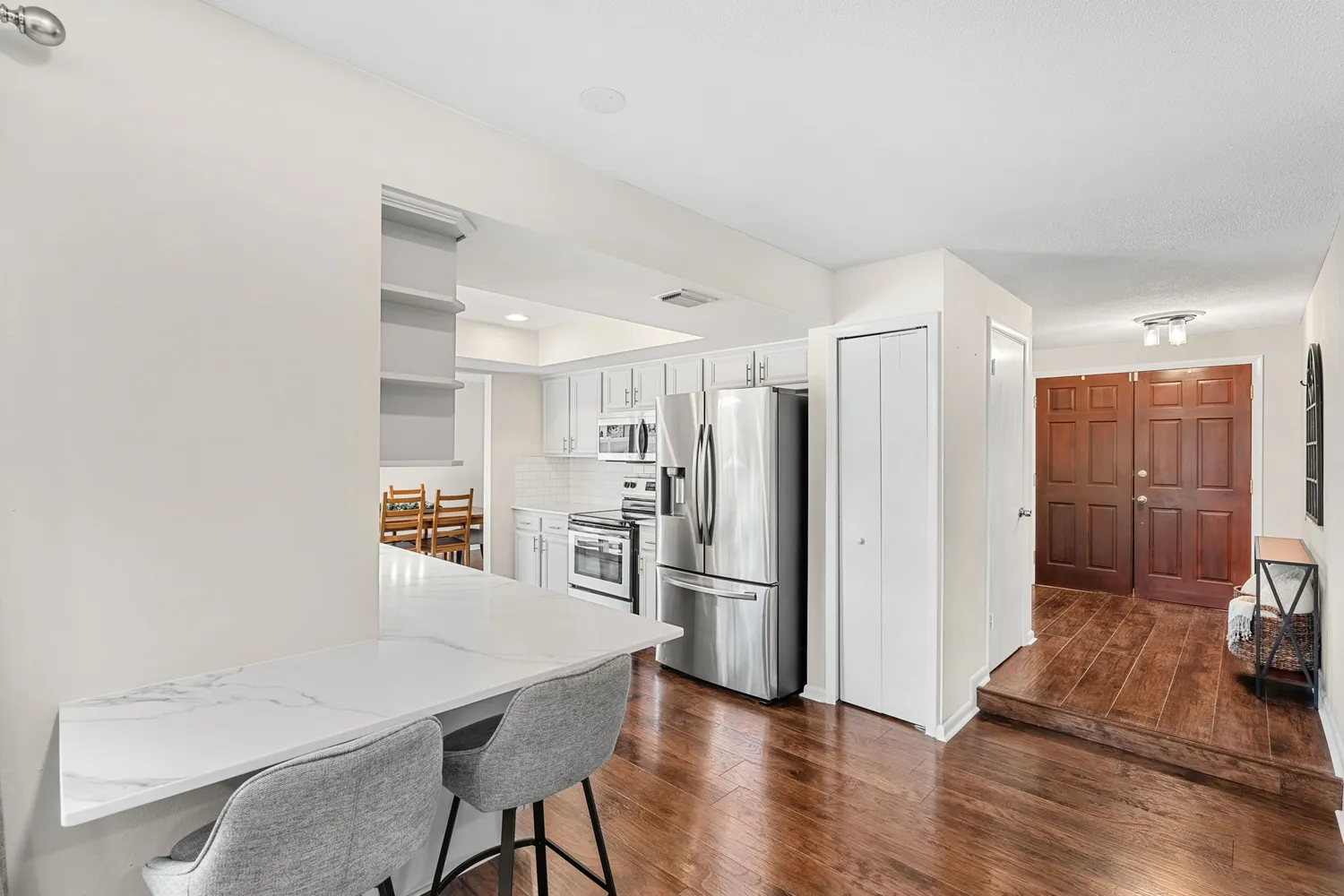a kitchen with stainless steel appliances a refrigerator and a stove top oven