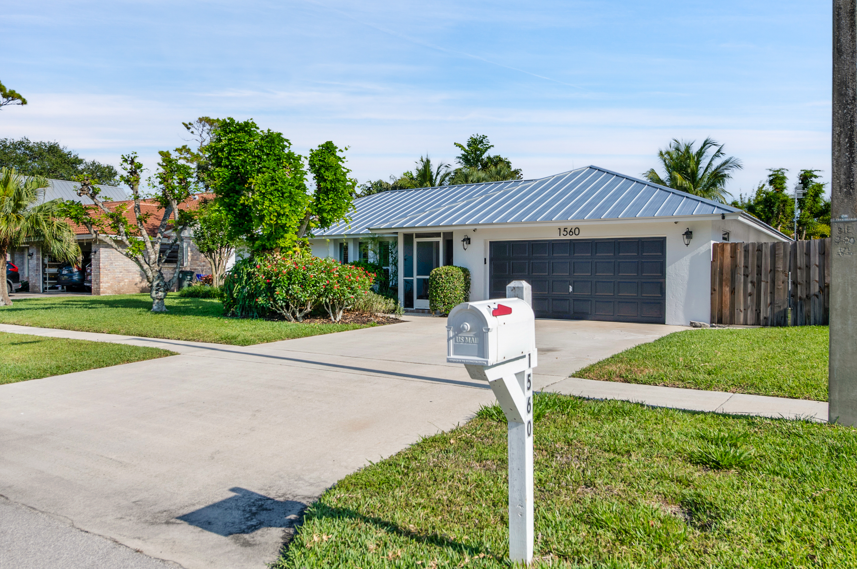 1560 Southwest 16th Street Boca Raton, FL 33486 - Photo 4 of 72 a front view of a house with garden