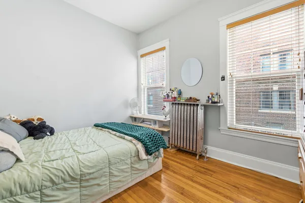 a bed sitting in a bedroom next to a window