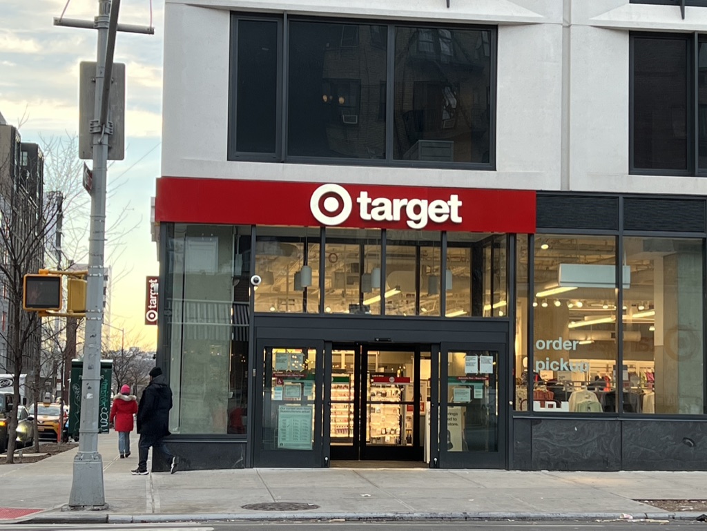 446 West 46th Street, Unit 16 Manhattan, NY 10036 - Photo 11 of 12 a view of a brick building with a red door and a man seat