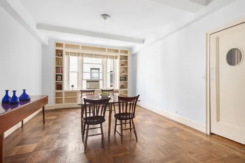 a dining room with furniture and wooden floor