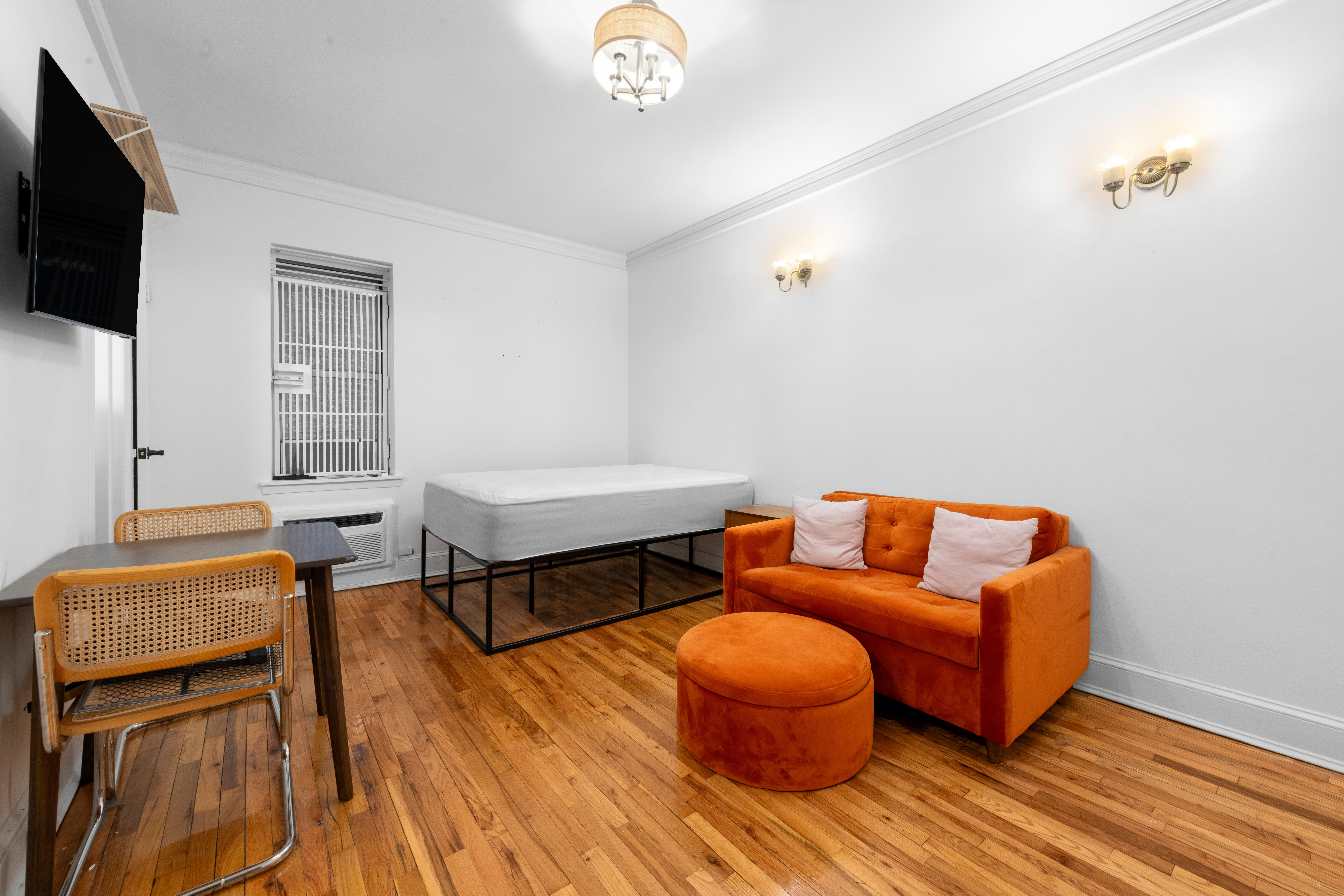 2790 Broadway, Unit 1B Manhattan, NY 10025 - Photo 2 of 8 a living room with furniture and a flat screen tv